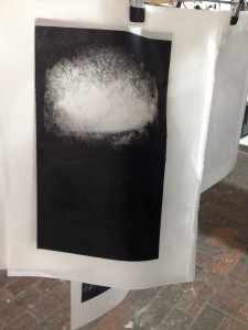 Monoprint image, black ink with extrusion to leave one white cloud formation, portrait aspect